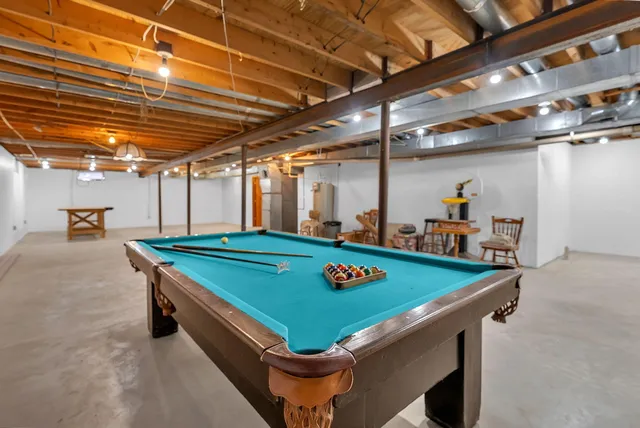 a kitchen with stainless steel appliances granite countertop a sink a refrigerator and a granite counter tops