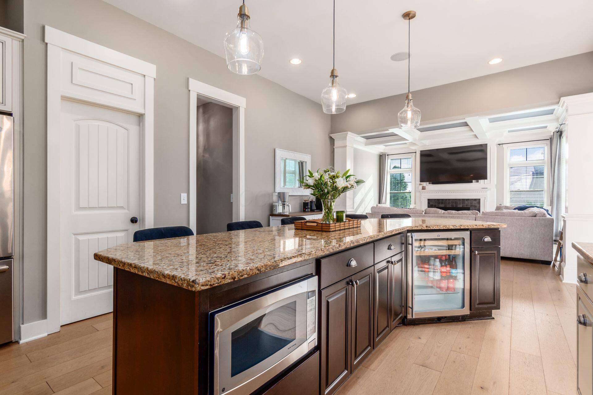 1002 Rambling Brook Way Delaware, OH 43015 - Photo 22 of 104 Spacious kitchen with center island, stainless steel appliances including gas range and double oven, built in microwave, beverage refrigerator, walk-in pantry and sunny breakfast room.