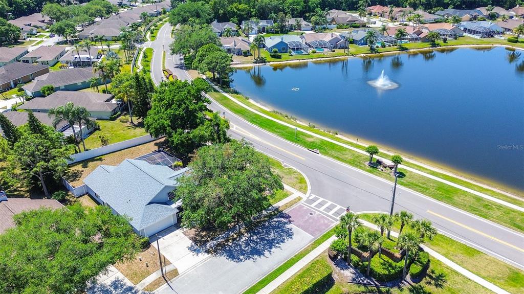 7730 Grimsby Lane New Port Richey, FL 34655 - Photo 12 of 48 an aerial view of a house with a swimming pool outdoor seating and yard