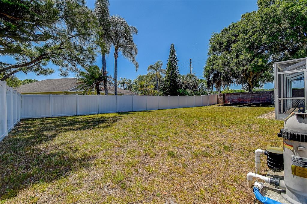 7730 Grimsby Lane New Port Richey, FL 34655 - Photo 16 of 48 a view of swimming pool with seating area and trees around