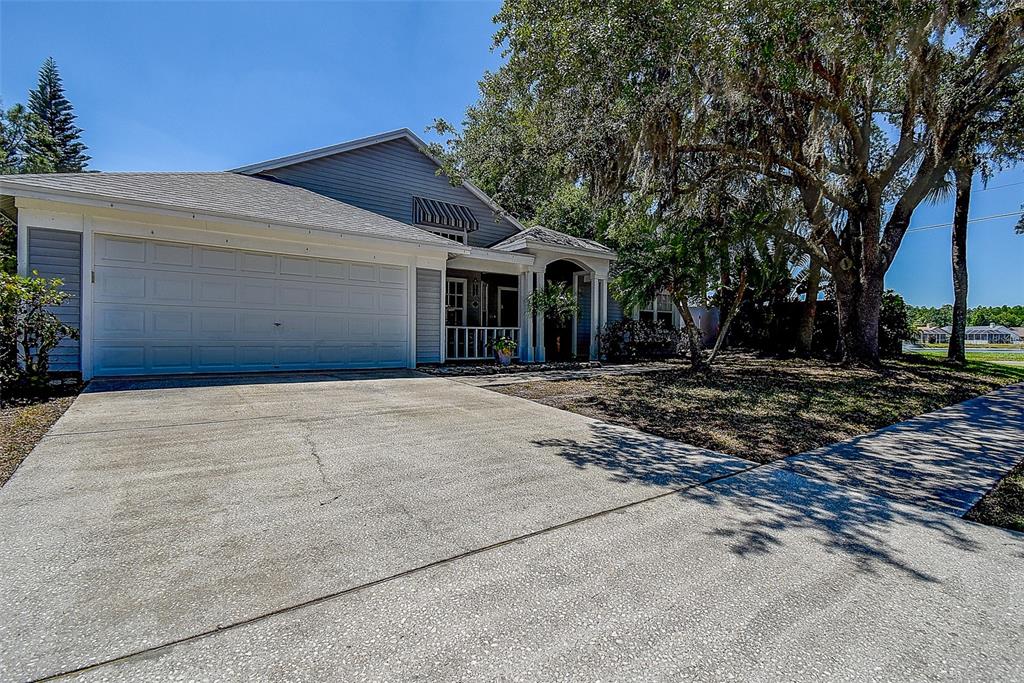 7730 Grimsby Lane New Port Richey, FL 34655 - Photo 2 of 48 a front view of a house with a yard