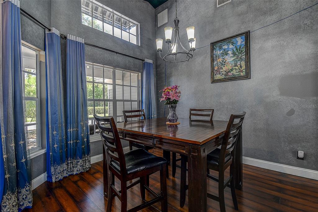 7730 Grimsby Lane New Port Richey, FL 34655 - Photo 24 of 48 a view of a dining room with furniture window and wooden floor
