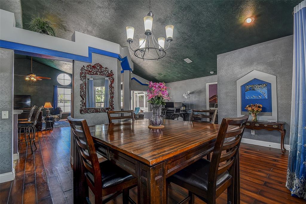 7730 Grimsby Lane New Port Richey, FL 34655 - Photo 25 of 48 a view of a dining room with furniture and wooden floor