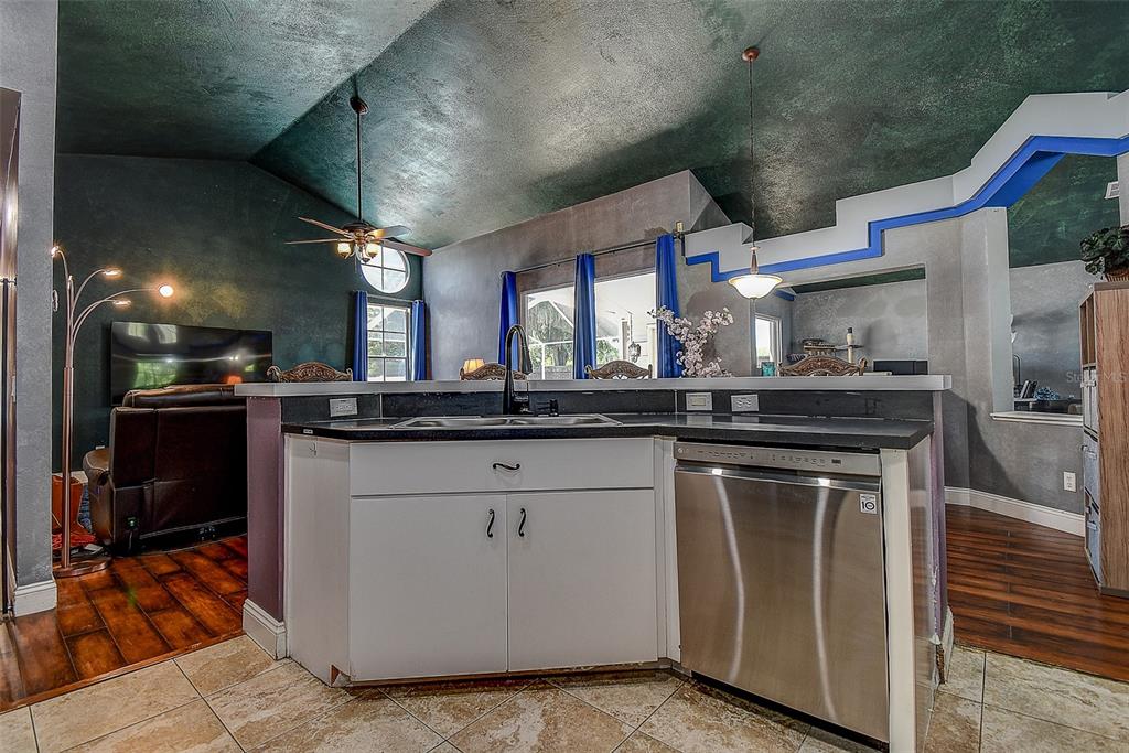 7730 Grimsby Lane New Port Richey, FL 34655 - Photo 32 of 48 a kitchen with stainless steel appliances granite countertop a stove a sink and a refrigerator