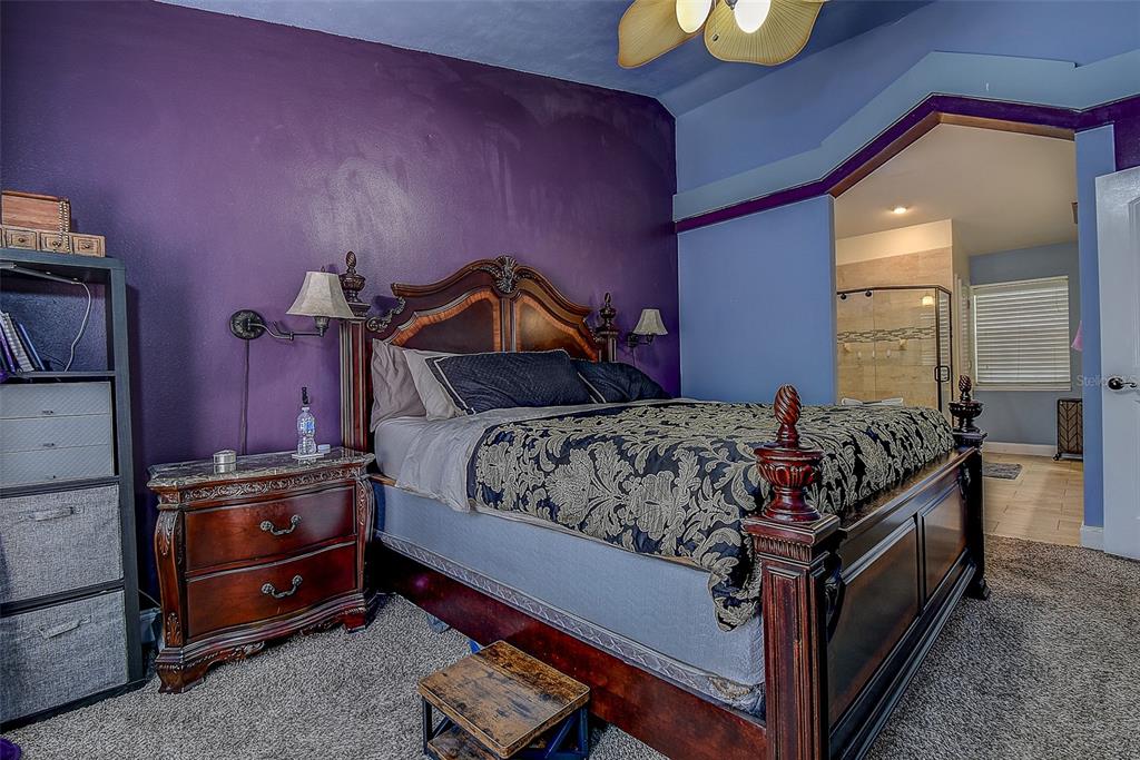 7730 Grimsby Lane New Port Richey, FL 34655 - Photo 37 of 48 a bed sitting in a room next to a lamp