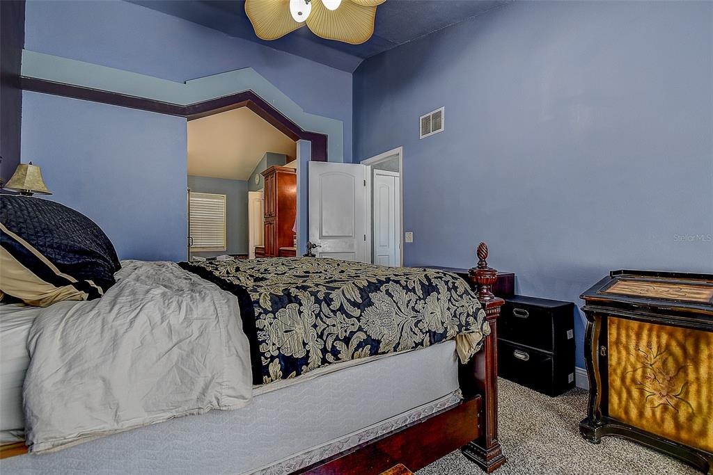 7730 Grimsby Lane New Port Richey, FL 34655 - Photo 38 of 48 a bed sitting in a bedroom next to a window
