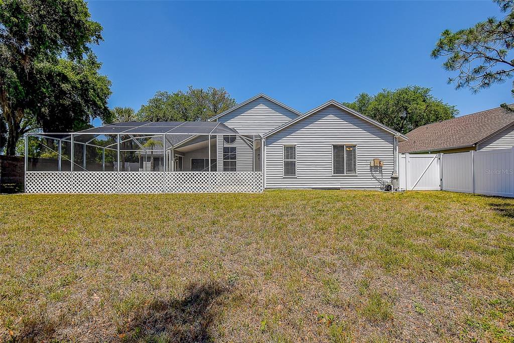 7730 Grimsby Lane New Port Richey, FL 34655 - Photo 4 of 48 a house with trees in the background