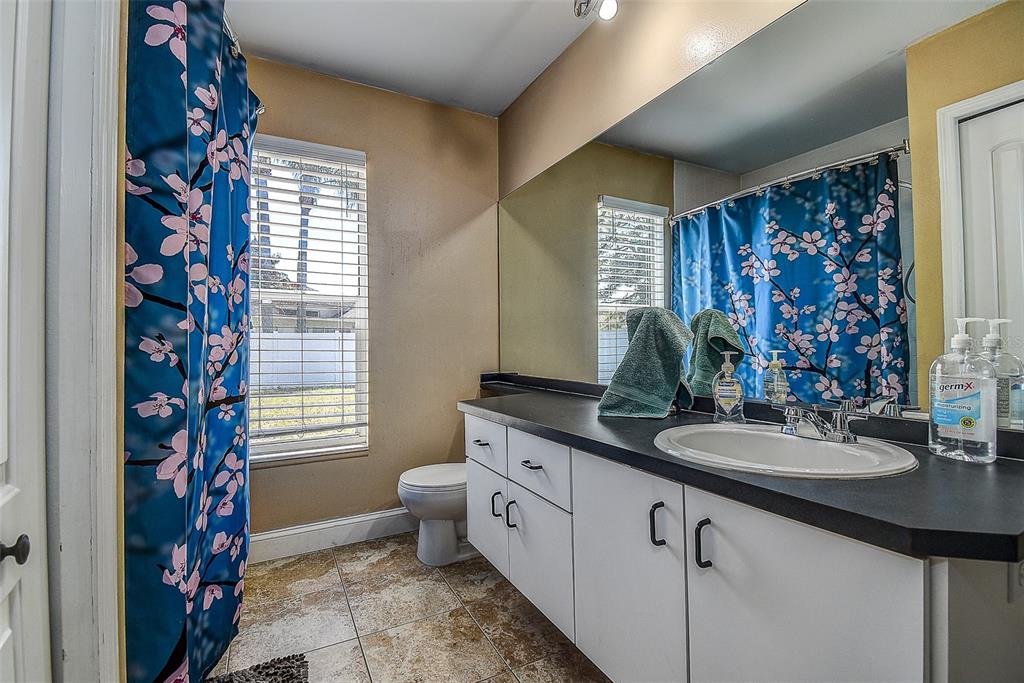 7730 Grimsby Lane New Port Richey, FL 34655 - Photo 43 of 48 a bathroom with double vanity and a mirror