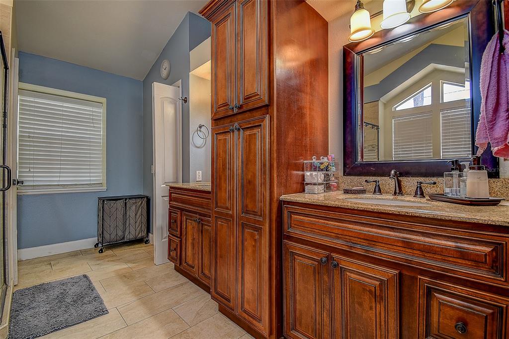 7730 Grimsby Lane New Port Richey, FL 34655 - Photo 45 of 48 a bathroom with a sink a mirror and a bathtub