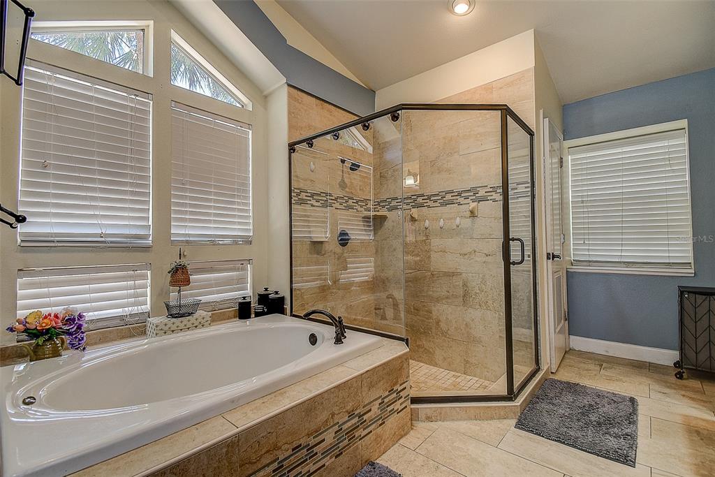 7730 Grimsby Lane New Port Richey, FL 34655 - Photo 47 of 48 a bathroom with a tub and a shower