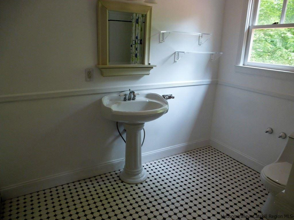 30 Peak Road Stone Ridge, NY 12484 - Photo 11 of 22 a bathroom with a sink a toilet and mirror