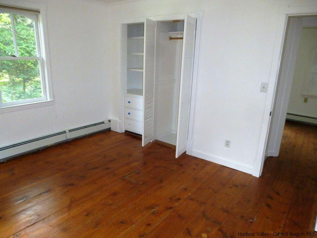 30 Peak Road Stone Ridge, NY 12484 - Photo 8 of 22 an empty room with wooden floor and windows