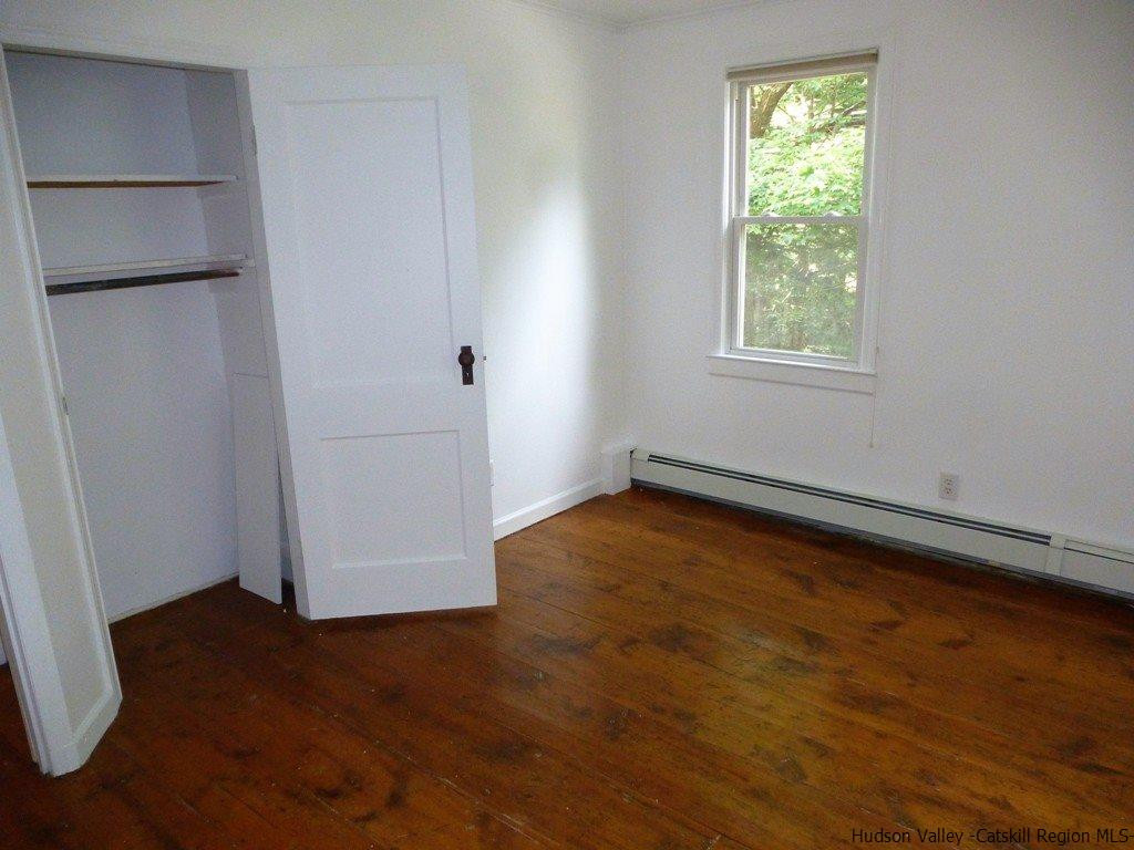 30 Peak Road Stone Ridge, NY 12484 - Photo 9 of 22 an empty room with wooden floor and windows