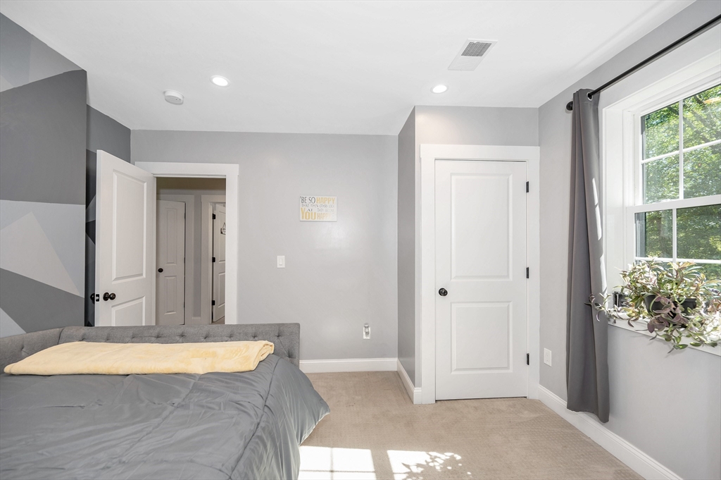 6 Edgehill Road Billerica, MA 01862 - Photo 5 of 15 a spacious bedroom with a bed and a window