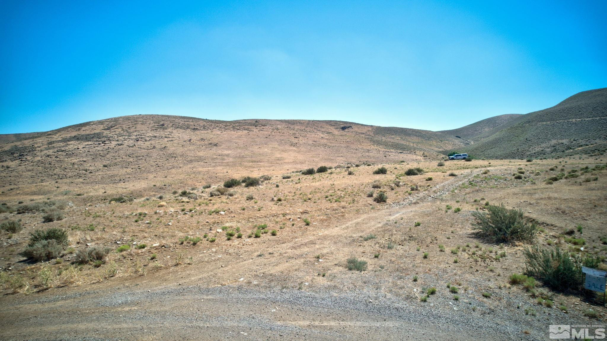 Apn 5017039th Road, Unit D Reno, NV 89521 - Photo 8 of 11 a view of a dry yard with mountains in the background