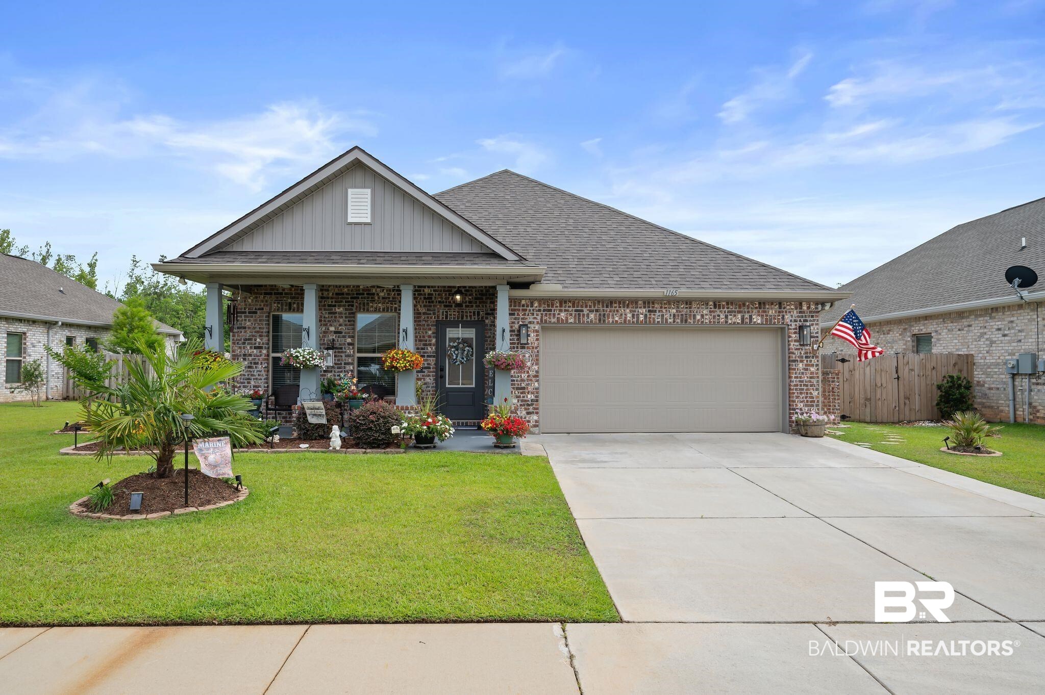 1165 Stella Road Foley, AL 36535 - Photo 35 of 42 Craftsman-style home with board and batten siding, a garage, concrete driveway, and brick siding