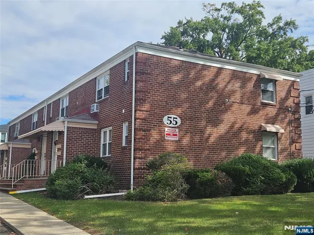 a brick building with a yard in front of it