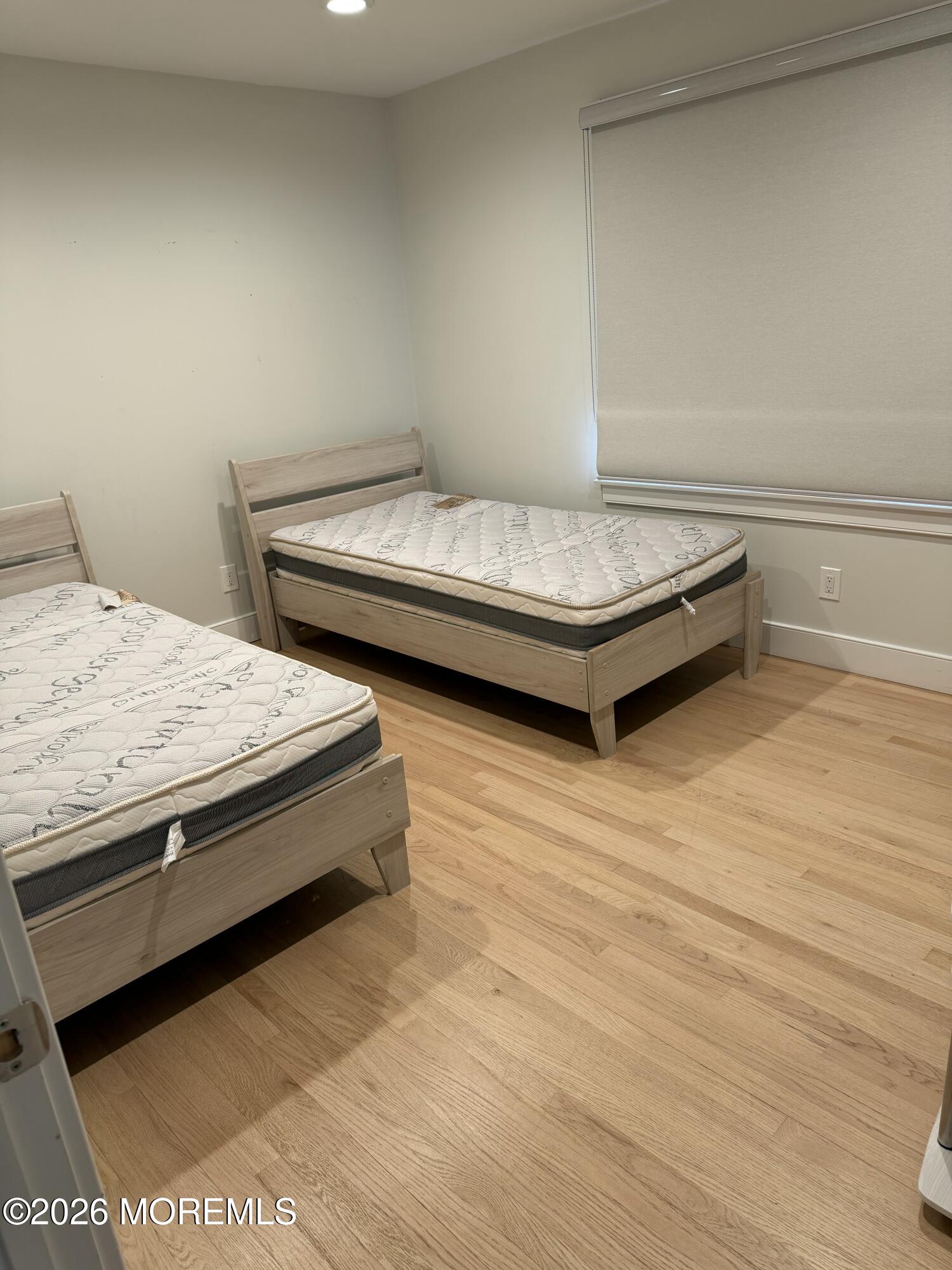 2025 Lesser Parkway Oakhurst, NJ 07755 - Photo 11 of 12 a bedroom with a bed and a table