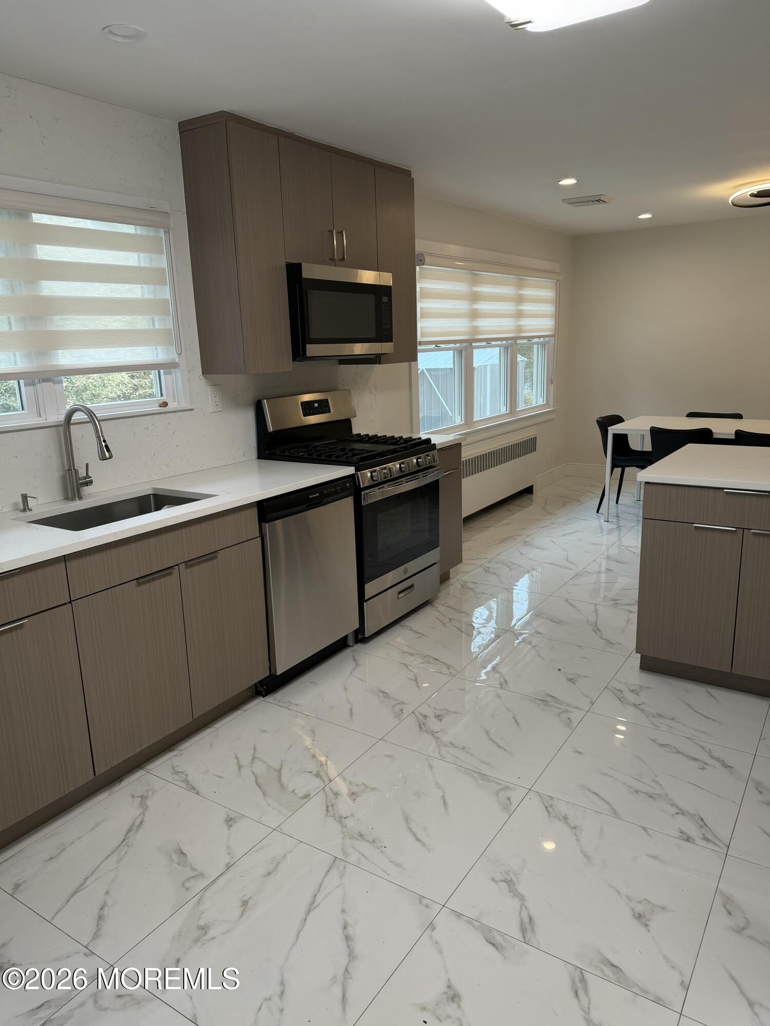 2025 Lesser Parkway Oakhurst, NJ 07755 - Photo 3 of 12 a kitchen with a sink and a stove top oven