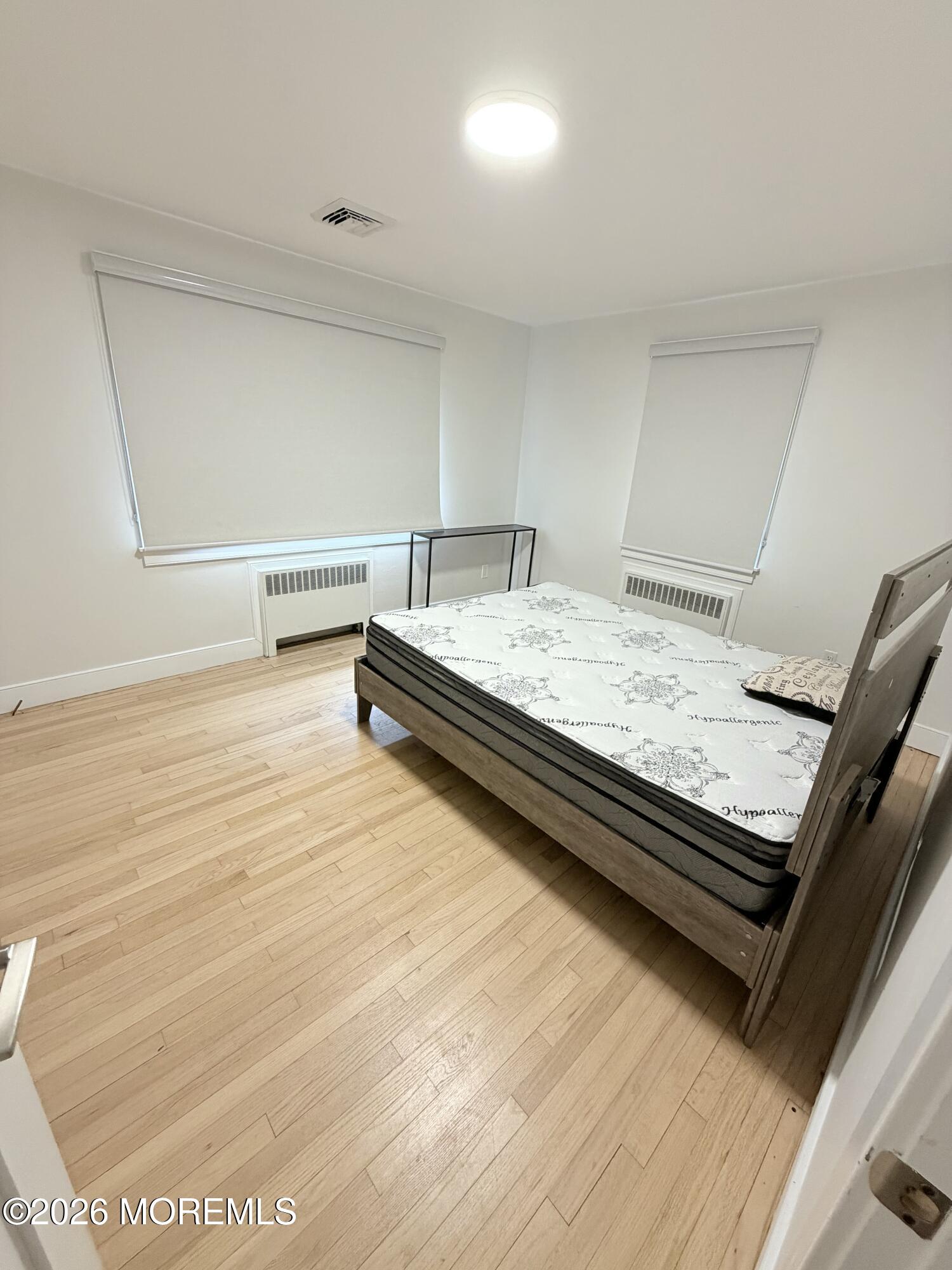2025 Lesser Parkway Oakhurst, NJ 07755 - Photo 4 of 12 a view of a room with wooden floor and bathroom
