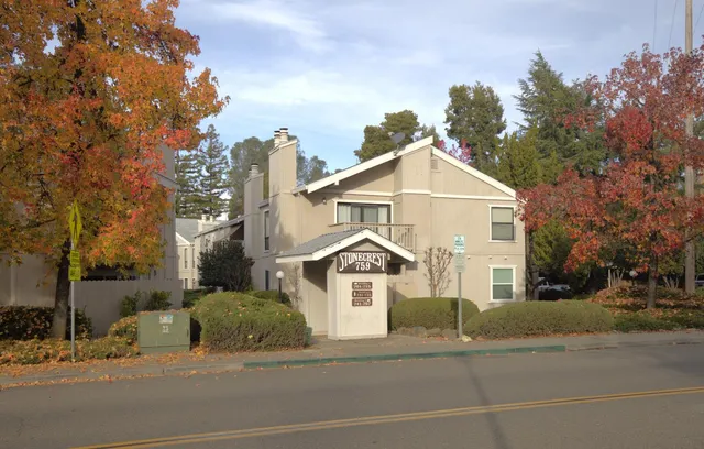 a view of a white house with a street