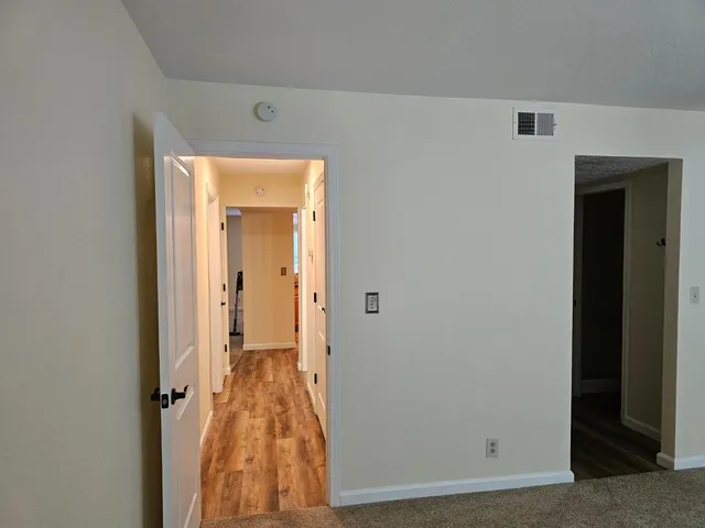 a bathroom with a granite countertop sink toilet mirror and shower