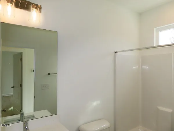 a bathroom with a shower and a toilet