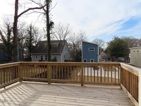 a balcony with wooden floor and fence