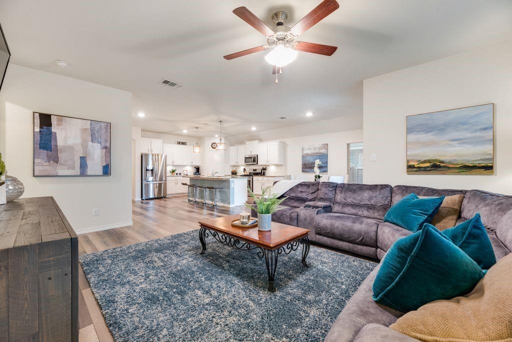 3404 Rio Grande Road Little Elm, TX 75068 - Photo 20 of 39 Open-concept living area that seamlessly connects the living room, dining space, and kitchen—creating an ideal layout for everyday living and entertaining.