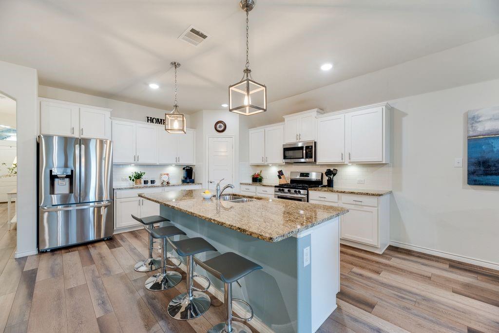 3404 Rio Grande Road Little Elm, TX 75068 - Photo 2 of 39 Beautiful cabinetry, under-cabinet lighting, and plenty of storage for everyday living and entertaining.