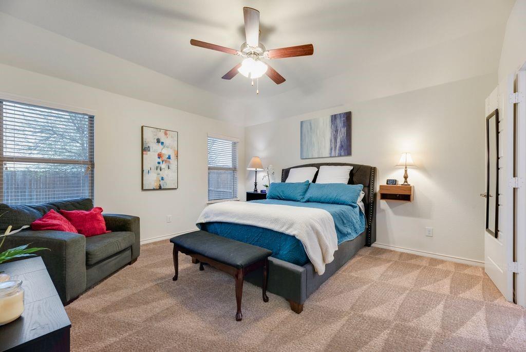 3404 Rio Grande Road Little Elm, TX 75068 - Photo 21 of 39 Spacious primary suite featuring plush carpeting, abundant natural light, and plenty of room for a comfortable seating area.
