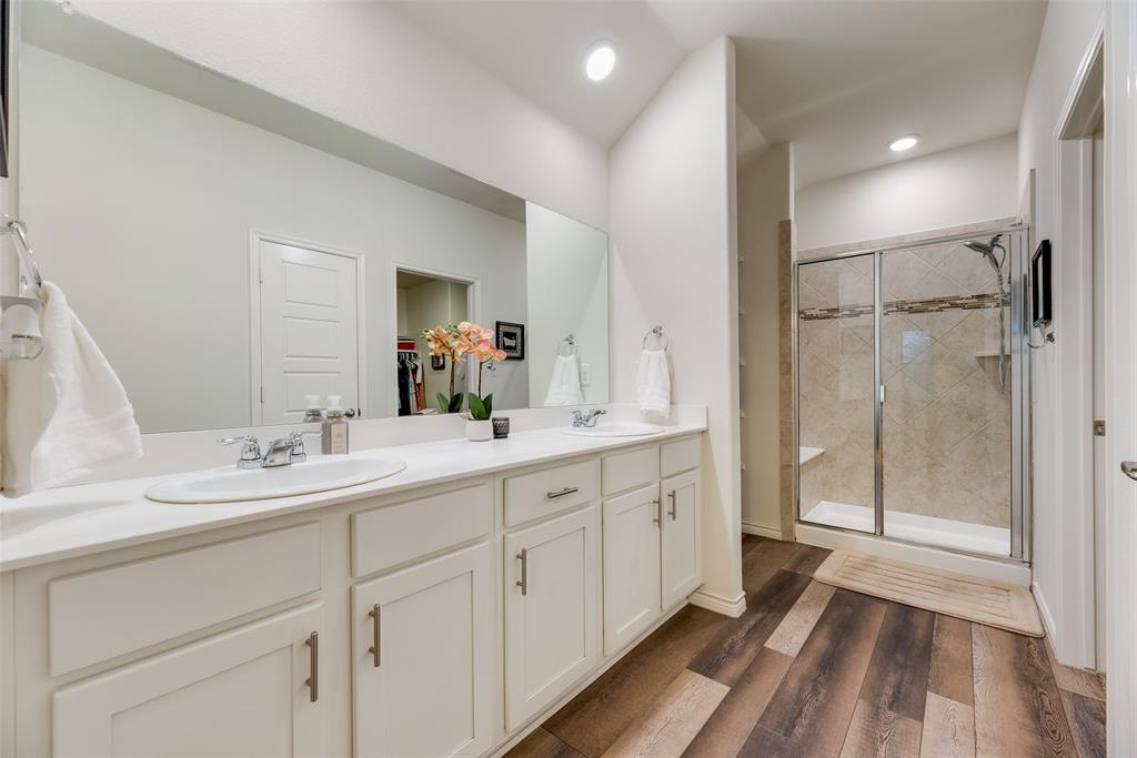 3404 Rio Grande Road Little Elm, TX 75068 - Photo 23 of 39 Spacious primary bathroom featuring dual vanities, ample cabinet storage, and a beautiful walk-in shower for a relaxing retreat.
