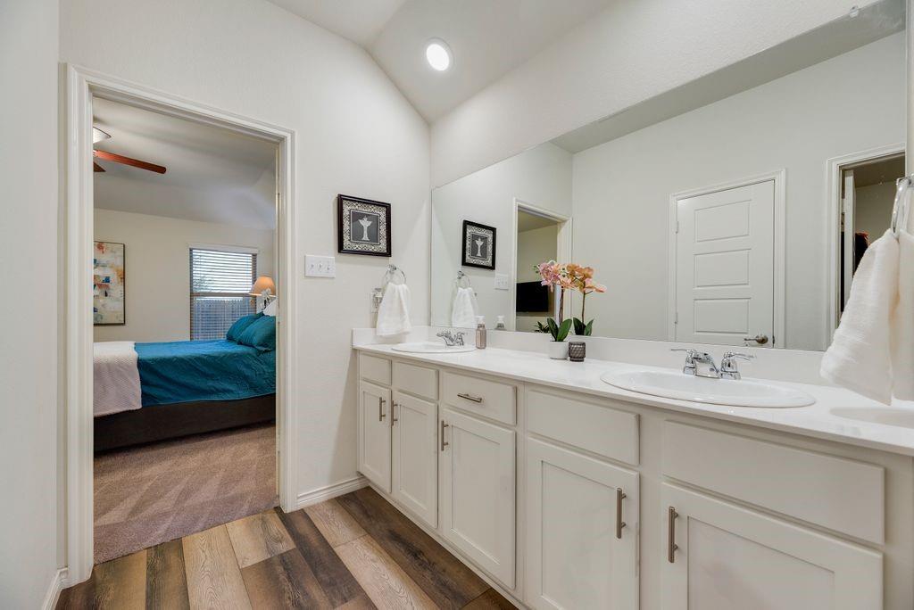 3404 Rio Grande Road Little Elm, TX 75068 - Photo 27 of 39 primary bathroom featuring dual vanities, ample cabinet storage, and a beautiful walk-in shower for a relaxing retreat.