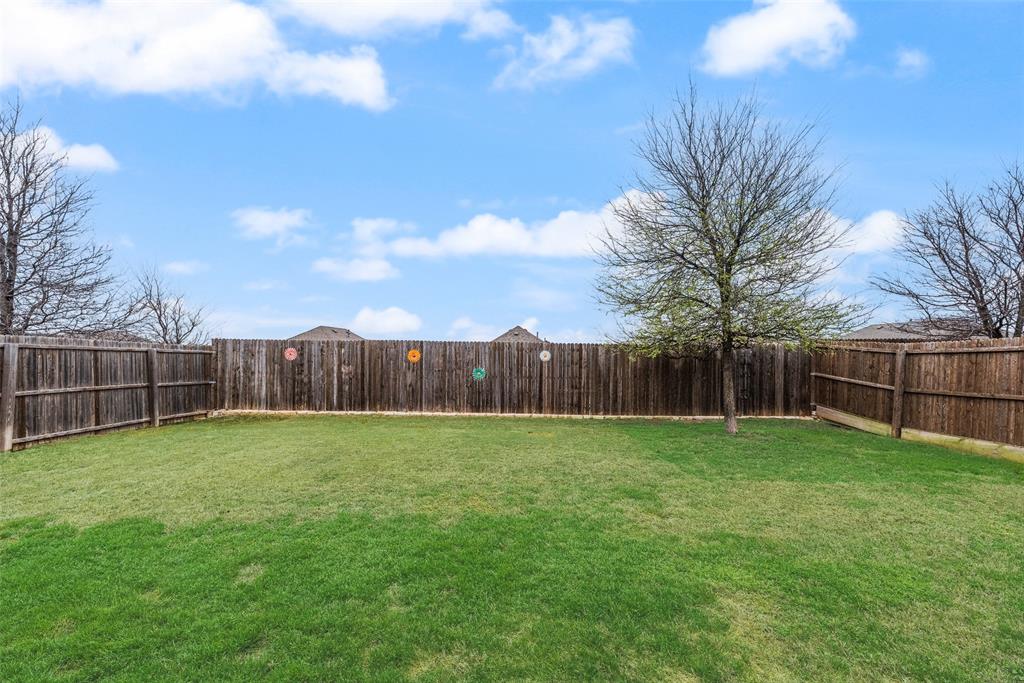 3404 Rio Grande Road Little Elm, TX 75068 - Photo 30 of 39 Spacious fenced backyard offering plenty of room for outdoor activities, gardening, play, or creating your own backyard retreat.