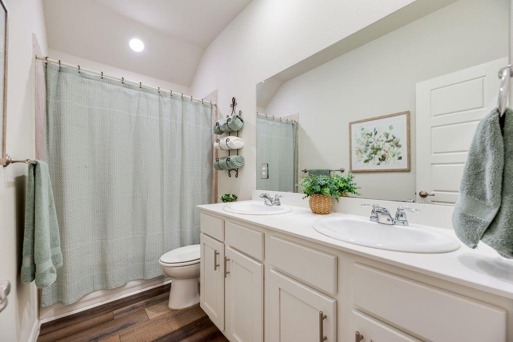 3404 Rio Grande Road Little Elm, TX 75068 - Photo 8 of 39 Bright secondary bathroom featuring a spacious double vanity, ample storage, and a full shower/tub combo for everyday convenience.