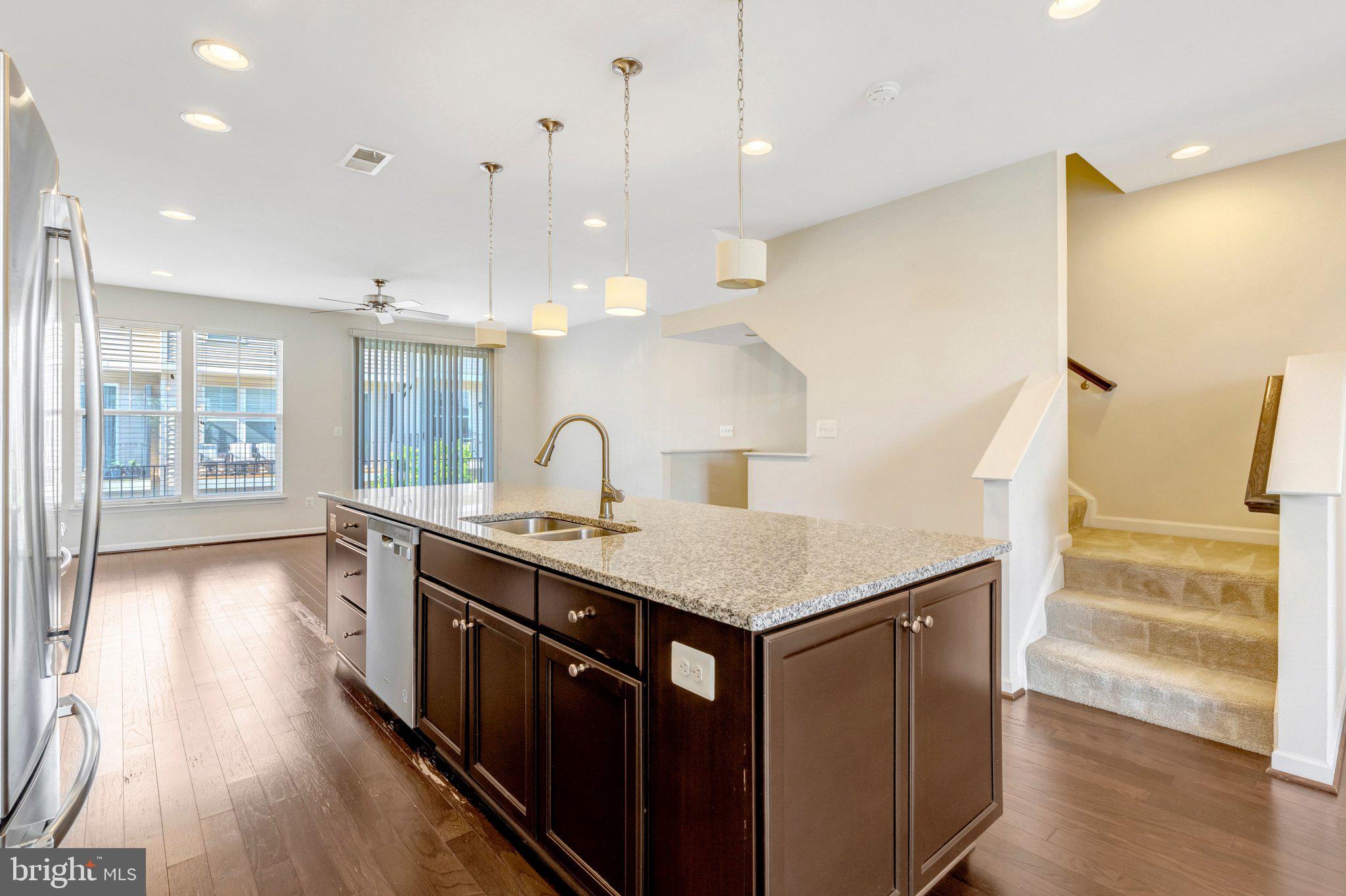 8932 Dahlgren Ridge Road Manassas, VA 20111 - Photo 12 of 41 a kitchen with a stove a sink a refrigerator and wooden floor
