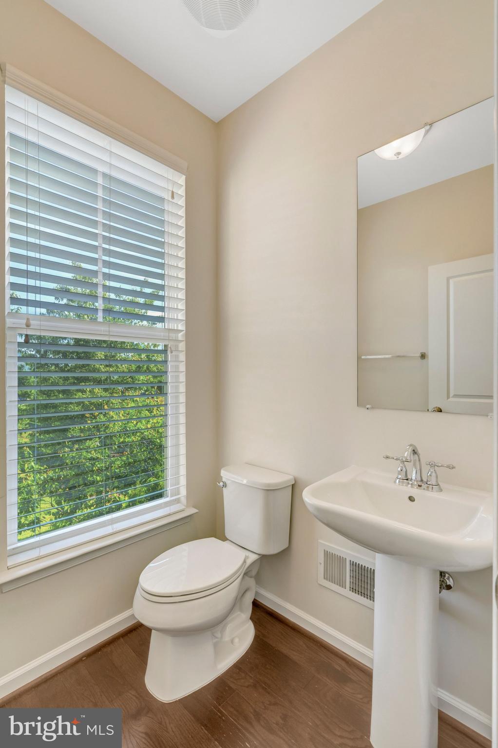 8932 Dahlgren Ridge Road Manassas, VA 20111 - Photo 21 of 41 a bathroom with a sink a toilet and a window