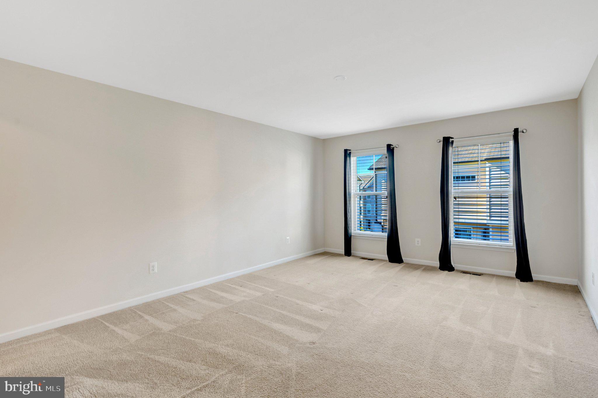 8932 Dahlgren Ridge Road Manassas, VA 20111 - Photo 22 of 41 a view of an empty room with wooden floor and closet
