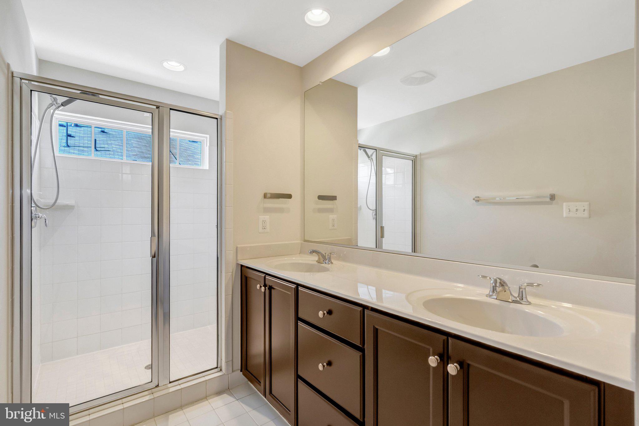 8932 Dahlgren Ridge Road Manassas, VA 20111 - Photo 25 of 41 a bathroom with a granite countertop sink mirror and double