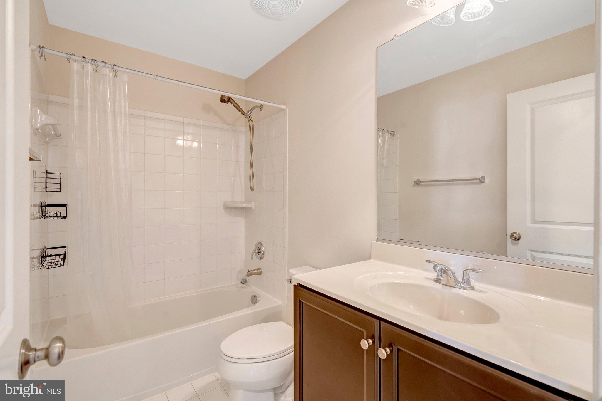 8932 Dahlgren Ridge Road Manassas, VA 20111 - Photo 33 of 41 a bathroom with a granite countertop sink toilet and shower