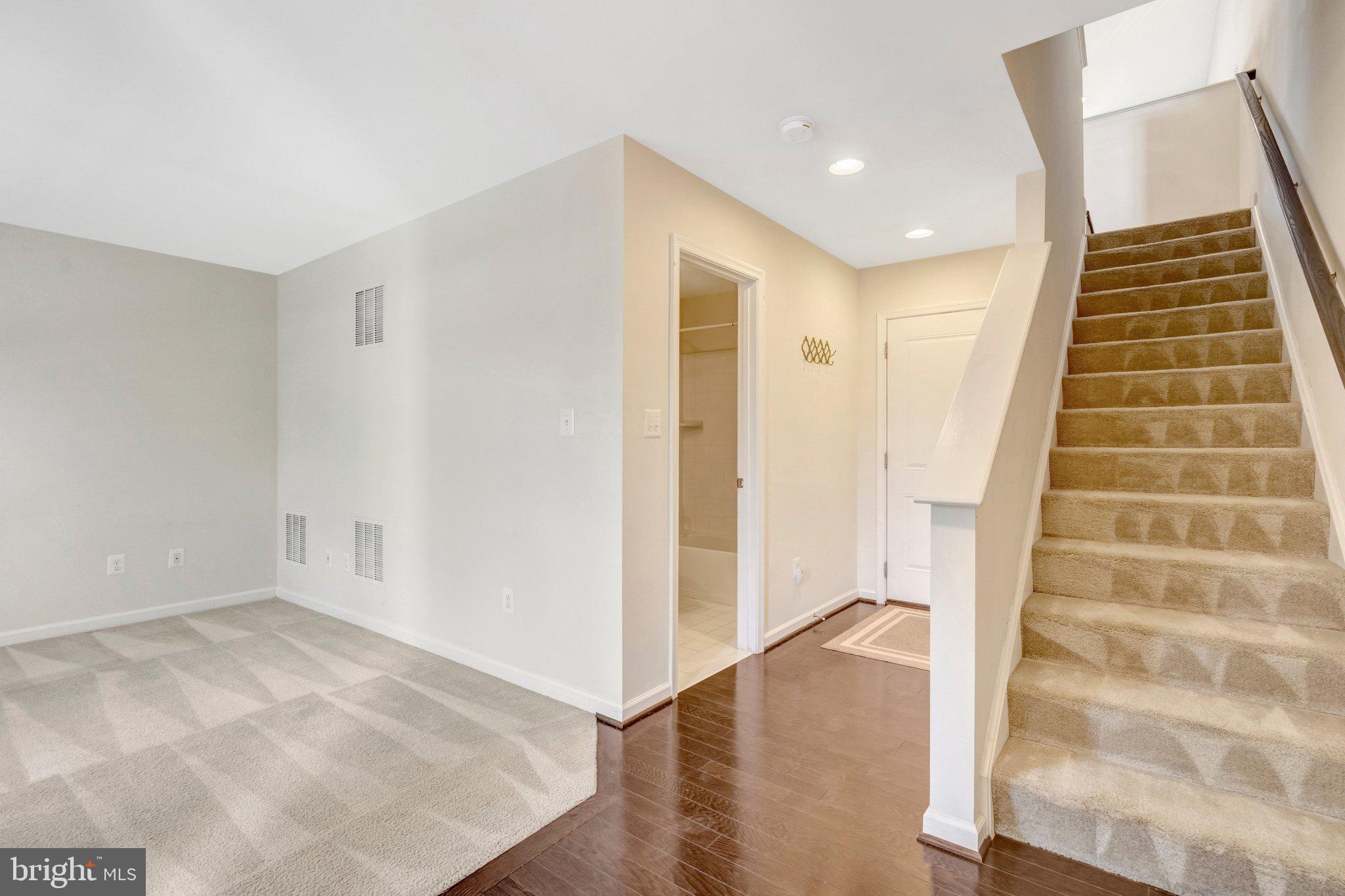 8932 Dahlgren Ridge Road Manassas, VA 20111 - Photo 4 of 41 a view of room with stairs and wooden floor