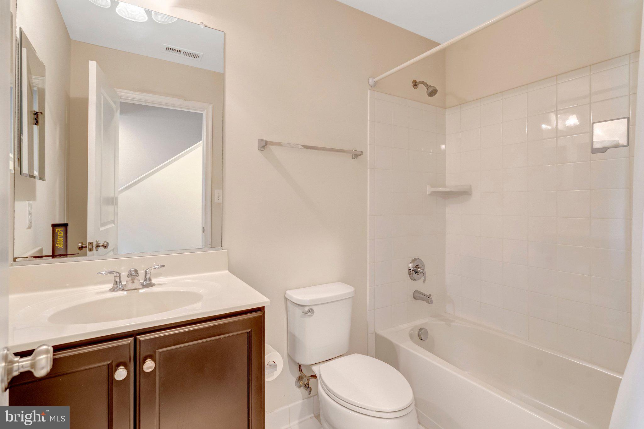 8932 Dahlgren Ridge Road Manassas, VA 20111 - Photo 7 of 41 a bathroom with a sink a toilet and shower