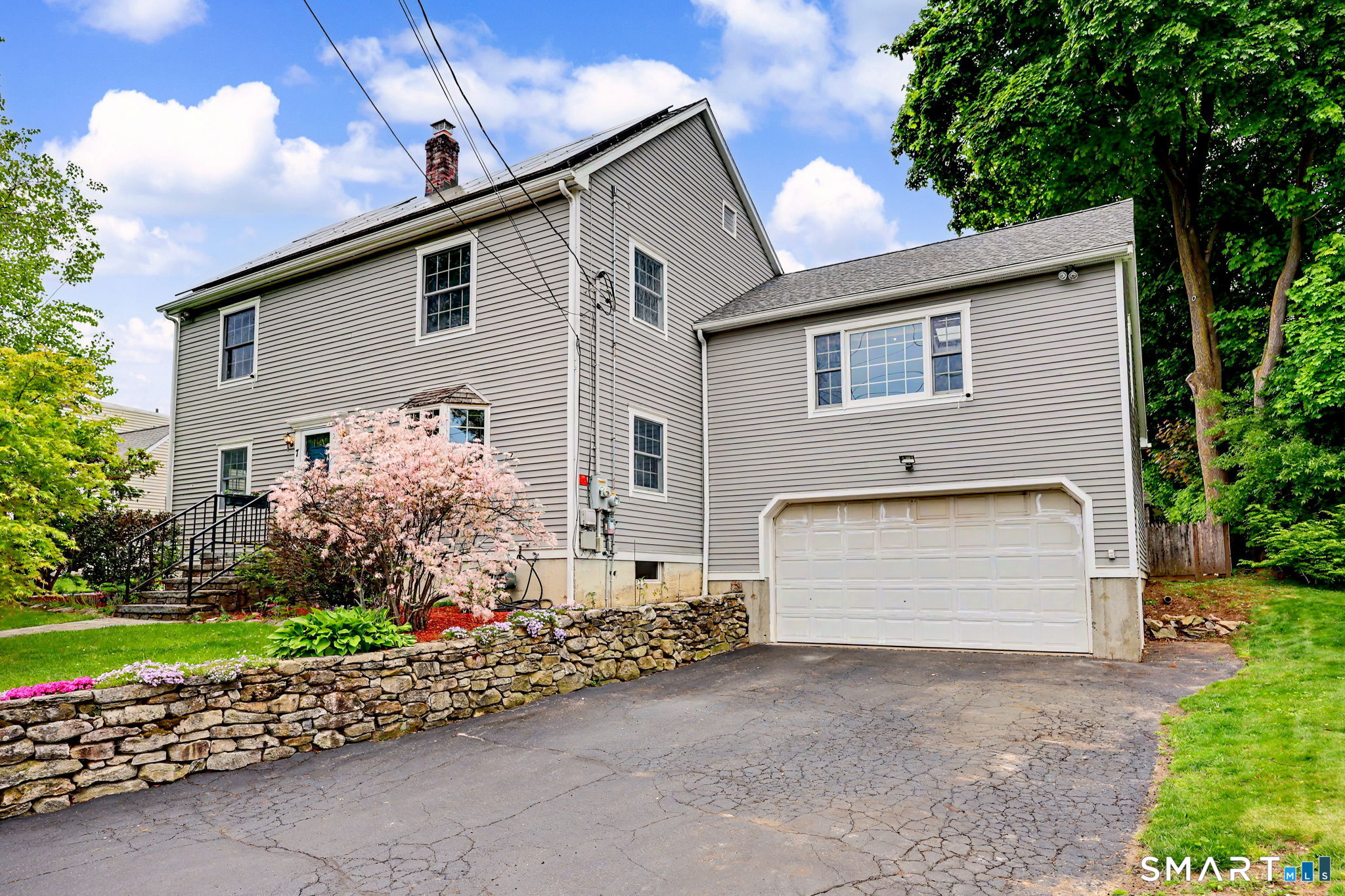 7 Merrill Road Trumbull, CT 06611 - Photo 2 of 40 a front view of a house with a yard and garage