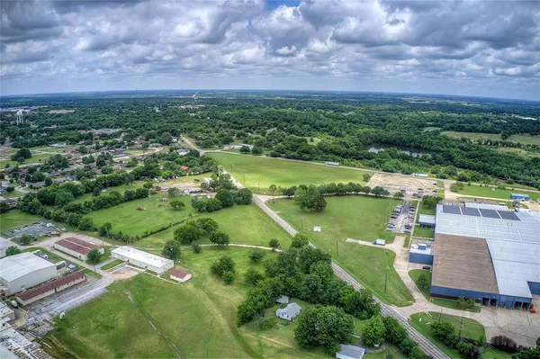 an aerial view of residential houses with outdoor space and lake view