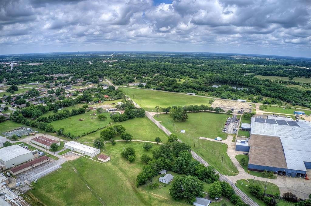 221 Maple Street Commerce, TX 75428 - Photo 1 of 19 an aerial view of residential houses with outdoor space and lake view