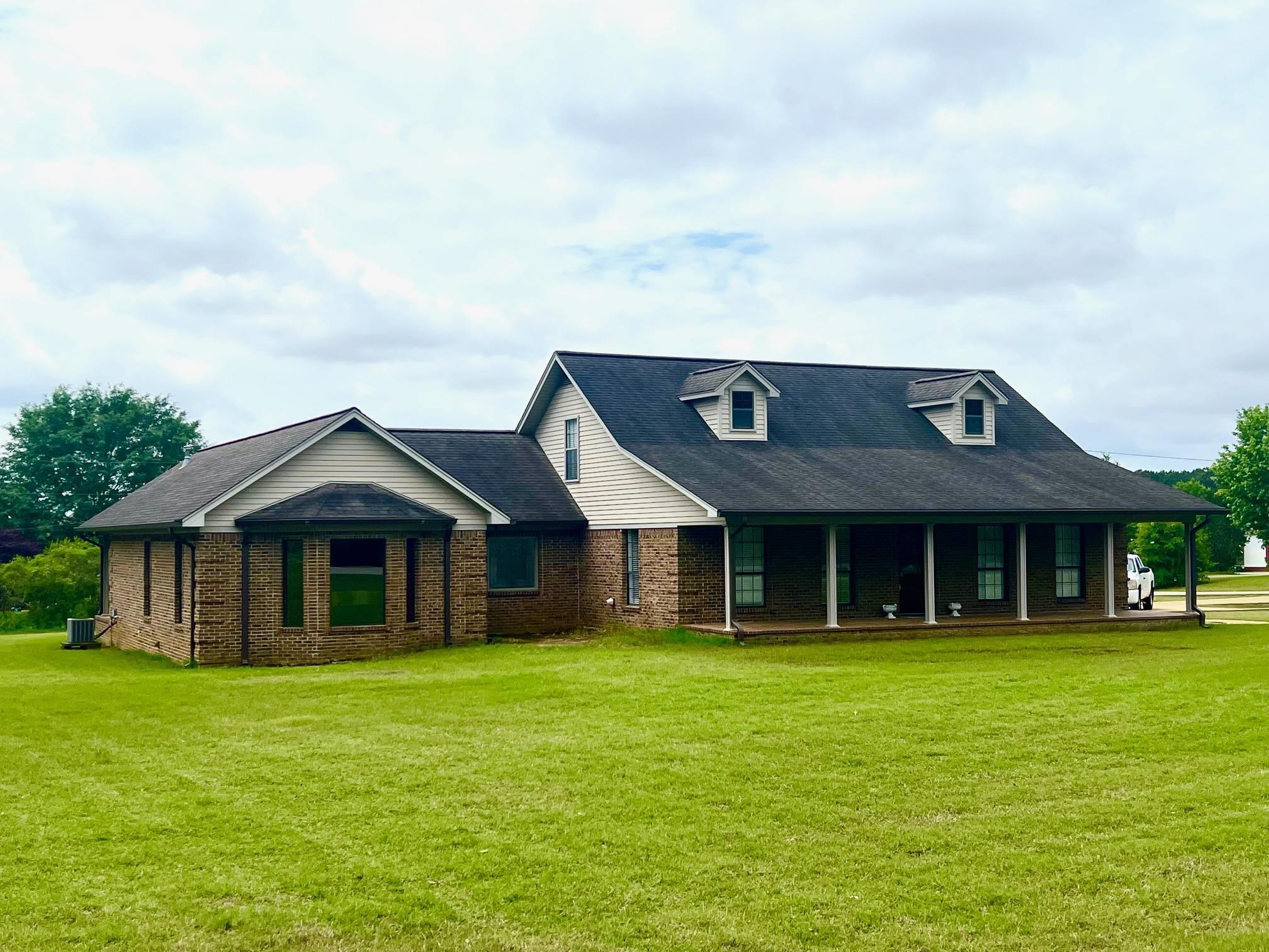a front view of a house with a garden