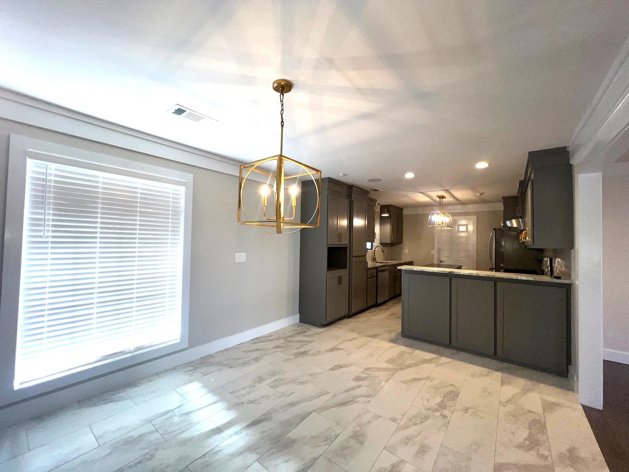 101 Peacock Holler Ripley, MS 38663 - Photo 5 of 25 a kitchen with stainless steel appliances kitchen island granite countertop a refrigerator a oven a sink with a dining table and chairs