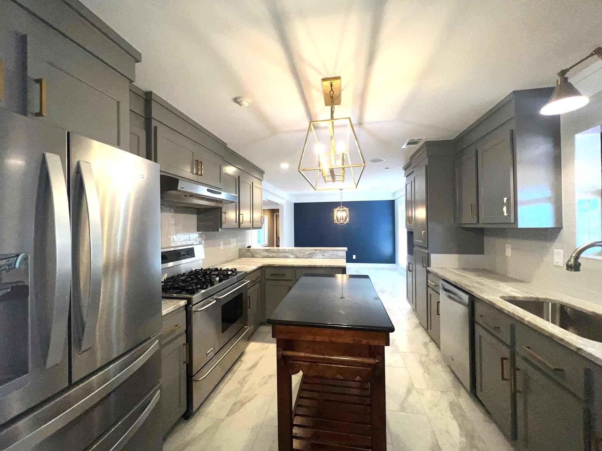 101 Peacock Holler Ripley, MS 38663 - Photo 8 of 25 a kitchen with stainless steel appliances granite countertop a sink a stove and a refrigerator