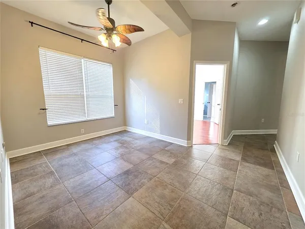 an empty room with closet and a chandelier fan