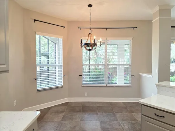 a kitchen with stainless steel appliances granite countertop a stove top oven a sink with wooden floor and cabinets